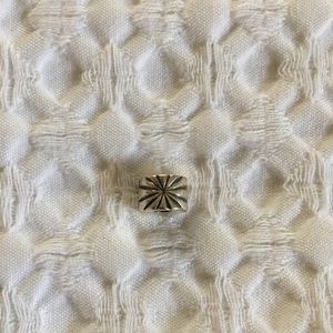 Silver starburst charm